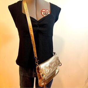 The Sak Platinum gold adjustable fold over crossbody bag